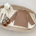 Detailed view of baby girl brown ribbed cotton top with ruffles and Mary Jane shoes - 66 / Brown