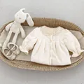 Detailed shot of beige corduroy girl coat with lace collar and ruffled cuffs on flat lay - 73cm / Off White
