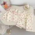 Detail of baby pajamas with cartoon bear print and soft pink trim on cream cotton - 73cm / Bear and Rabbit