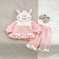Detail of pink fleece baby pajamas set featuring cute rabbit ears and ruffled hem - Top And Bottom / Pink / 73cm