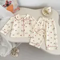 Close-up of cute rabbit strawberry print on baby pajamas with pink piping details - 73cm / Strawberry