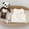 Detail of baby panda lamb wool vest with soft embroidery and small buttons in a basket - Tops / Panda Style / 73cm