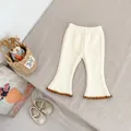 Close-up of cream flare pants featuring elastic waist and brown scalloped crochet edges - Apricot / 73cm
