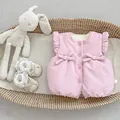 Detail of pink baby winter vest featuring textured fabric and cute bow accents - Pink / 73cm