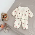 Dettaglio del pigiama in pile per neonata con stampa a ciliegie e bordo in pizzo - 73 / Top E Pantaloni / Ciliegia