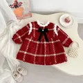 Detail of red tweed Christmas dress featuring white faux fur trim and black velvet bow - 73cm / Red Plaid