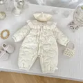 Flat lay of baby winter floral romper with quilted heart texture and lace collar detail - 66 / Beige Floral