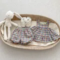 Flat lay of plaid baby girl summer set with ruffled camisole, shorts and lace shoes - Green Check / 73cm
