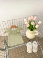 Close-up of light green ruffled sleeveless top with ribbed fabric in a cute shopping cart - Green / 66cm