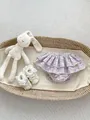 Detail of floral infant ruffled bloomer shorts with lace trim shoes and a bunny toy - 73