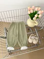 Detail view of bean green muslin cotton baby bloomers with delicate white lace hem cuffs - 66cm / Bottoms / Green