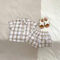 Detailed flat lay of boys plaid summer set with button shirt and elastic waist shorts - 73cm / Plaid