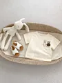 Detail of baby cotton t-shirt with cute rabbit print in an aesthetic nursery basket - 66 / Apricot