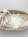Flat lay of polka dot baby romper with lace princess shoes and a knotted headband - 66CM / Polka Dot