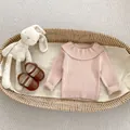 Detailed knit texture of pink ruffled collar sweater with baby shoes and plush rabbit - Pink Apricot / 73