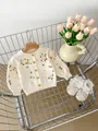Detail van geel en groen bloemenborduurwerk op een crème gebreid vest voor baby's - 66cm / Beige Abrikoos