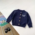 Detail of navy knit cardigan with wood buttons and white embroidery for kids - 73cm / Navy Blue