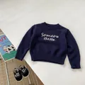 Detailed flat lay of a navy blue kids knit sweater with white embroidered lettering - Knit Cardigan / Navy Blue (Top) / 100cm