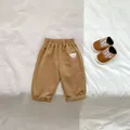 Detail of baby khaki pants featuring an elastic waist and a cute white bear embroidery - Casual Pants / Brown / 66