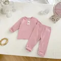 Detalle de conjunto de bebé en algodón acanalado rosa con lazos blancos suaves - Rosa / 73cm