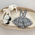 Detailed flat lay of checkered baby girl romper dress set with lace shoes in a basket - 66cm / Plaid Suspender Set
