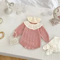 Detail of baby girl knitted bodysuit featuring white lace collar and cable knit texture - 66cm / Pink