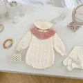 Detail of infant knit romper featuring ruffled pink collar and matching beret accessory - 66cm / Apricot