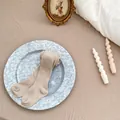 Nahaufnahme der haferflockenfarbenen Baby-Leggings aus geripptem Strick für den Herbst - S (12-24 Monate) / Khaki