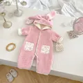 Detailed view of pink baby romper with bunny ears hood and floral patterned pockets - 90cm / Pink