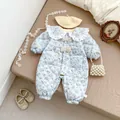 Detailed view of floral quilted baby romper with lace collar and bow accents - 66cm / Blue