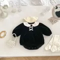 Close-up of velvet baby romper with bows, pearl bag, beret, and winged socks set - Black / 66cm