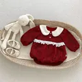 Close-up of red infant romper with white Peter Pan collar and delicate lace details - Red / 66cm