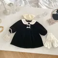 Detailed flat lay of velvet princess dress with Peter Pan collar and bow details - 73cm / Black