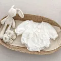 Detailed view of white baby romper with 3D diamond texture, lace edges, and matching shoes - White / 66cm