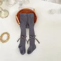 Close-up of charcoal gray ribbed knit baby tights with cute side ribbon bow decorations - XS (Length 40cm) / Bottoms / Lead Gray