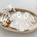 Detail of baby romper featuring bow embroidery on a lace Peter Pan collar and soft fabric - 66 / Beige