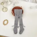 Detail of light gray baby footed tights featuring knit texture and side bow accents - XS (Length 40cm) / Bottoms / Smoke