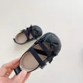 Close-up of black Mary Jane baby shoes with bows and elastic straps for toddlers - S (Inner Length 11cm) / Black
