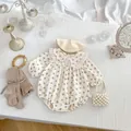 Detailed flat lay of floral baby romper with lace collar, beret, and ribbed tights - 66 / Floral