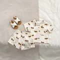 Dettaglio dell'anteprima del set estivo beige per neonati con stampe di bassotti marroni e tag - Bassotto Cartoon / 73cm