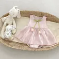 Detail of pink baby romper dress with green bow tie and 3D tulip floral decorations - 66cm / Tulip Style
