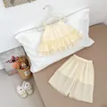 Detail of baby girl summer set featuring ruffled strap top and wide-leg shorts in cream - 73 / Apricot
