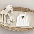Close-up of baby rib cotton top with cherry patch and lace trim shoes in a basket - 66CM / White Camisole Top