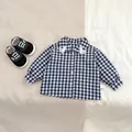 Detail of blue plaid baby shirt with duck embroidery and black canvas infant shoes - 66cm / Black And White Plaid Shirt