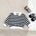 Detail of boys' striped long sleeve polo shirt with white lapel and ribbed cuffs - 73cm / Black