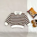Detail of baby striped cotton polo shirt with white collar and size 73 label - 73cm / Brown