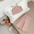 Detailed knit texture of pink toddler vest and flared pants with small flower accents - Pink Shirt And Pants Outfit / 73cm