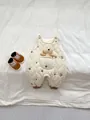Detail of baby quilted romper featuring brown star embroidery and a bear toy in pocket - Suspender Romper / 66cm