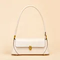 Elegant cream leather baguette bag with a gold buckle and slim shoulder strap - White