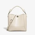 Chic beige leather bucket bag with silver turn-lock and adjustable shoulder strap - Cream